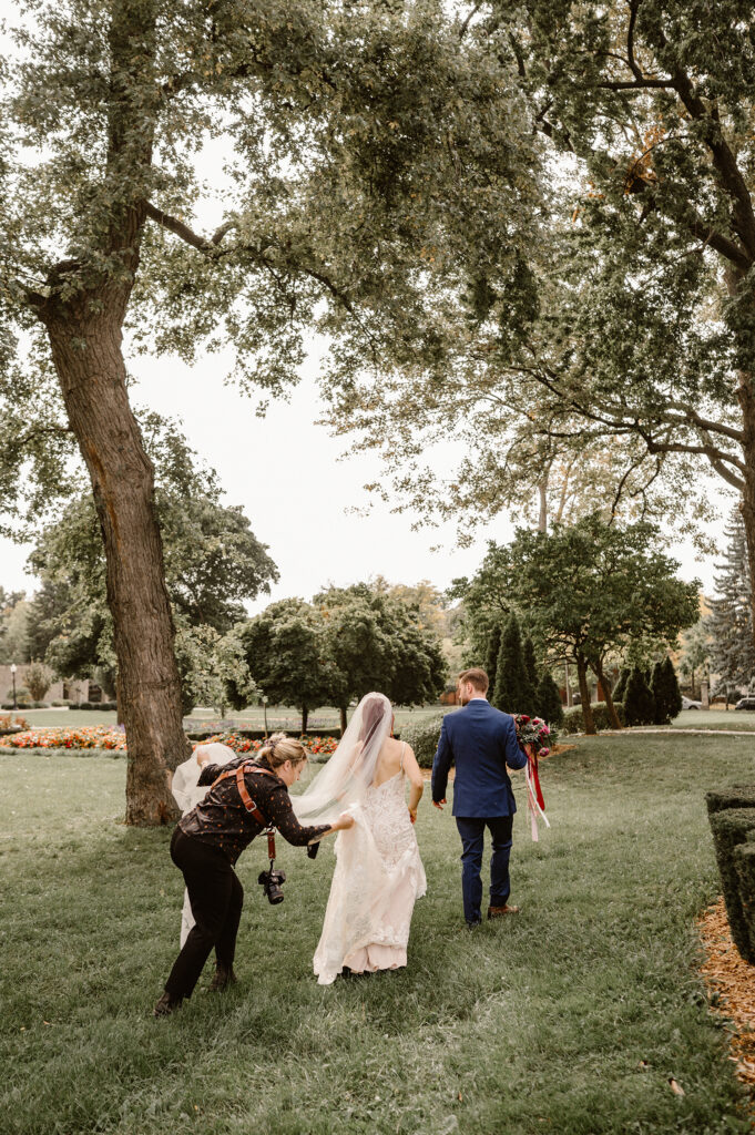 Carrie J. Photographer helping bride and groom with wedding day photos