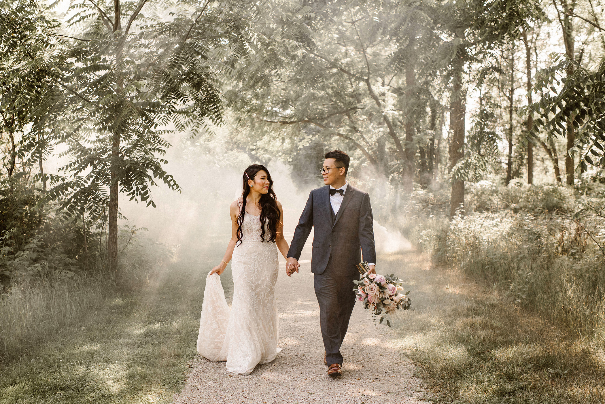 Bride and Groom walking in ambient light and smoke
