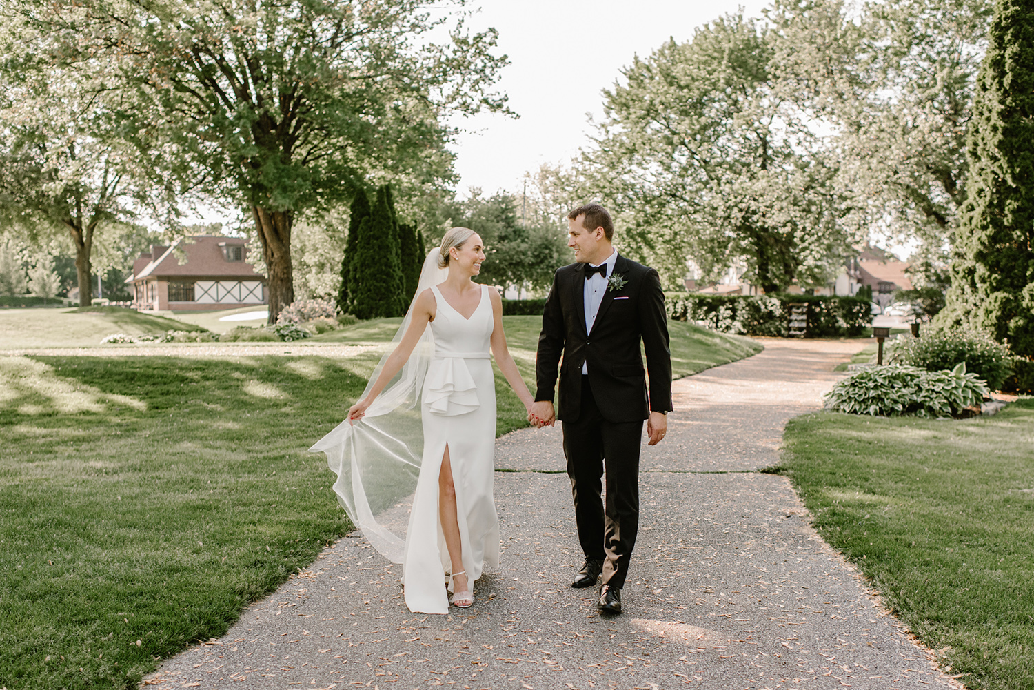 Bride and Groom walking together at Beach Grove Golf Club