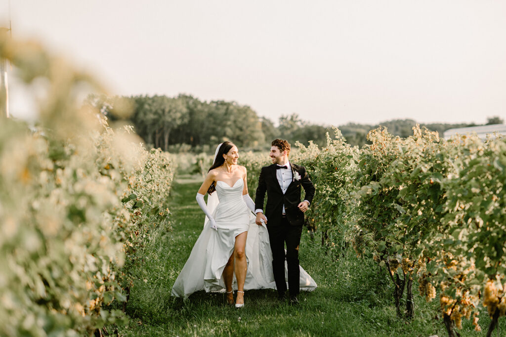 Bride and Groom running through vineyard at Mastronardi Winery