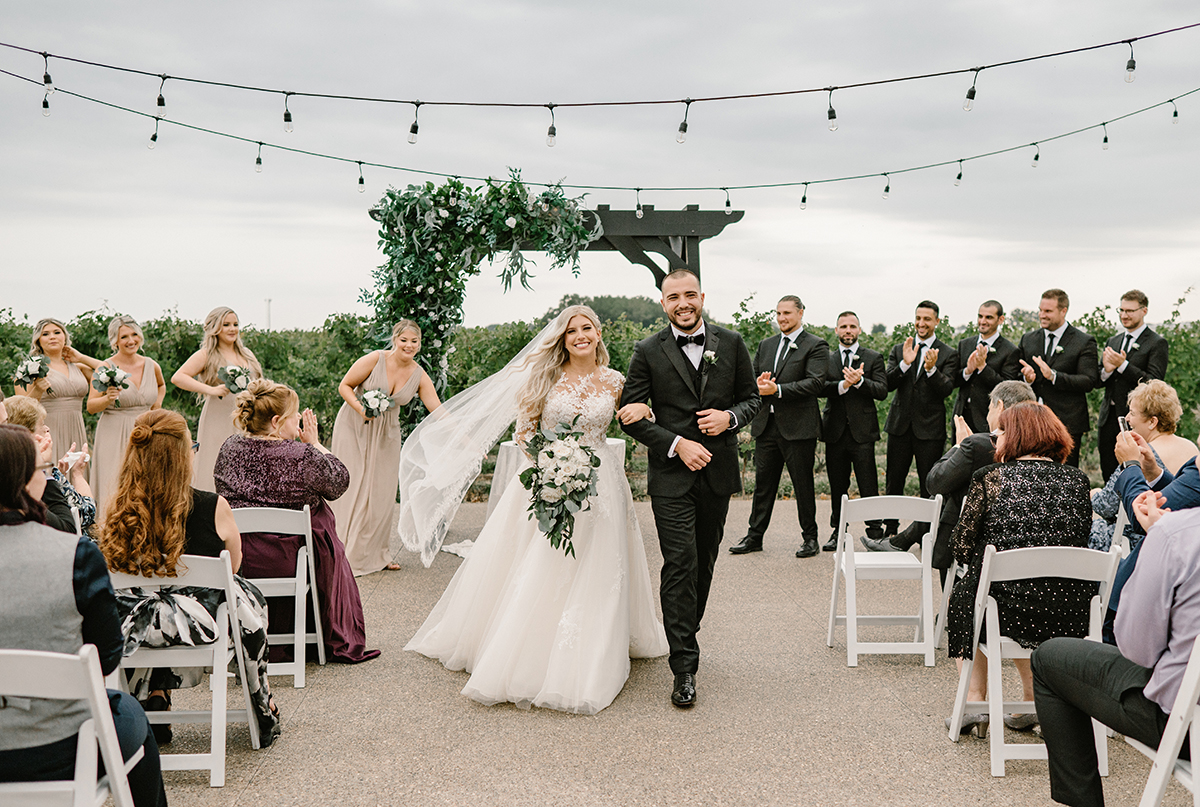 Bride and Groom walk down the aisle at Mastronardi Winery