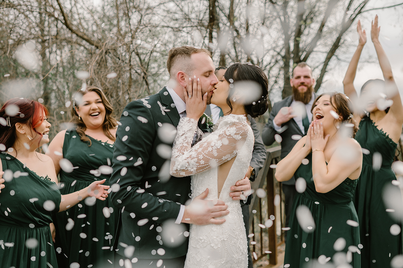 Bride and Groom getting sprinkled with confetti by wedding party